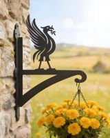 Digital representation of Liver Bird Iron Hanging Basket Bracket mounted on a farmhouse