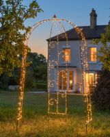 Digital representation of "Luxford" Scrollwork Gazebo in Situ in the Garden lit up with fairy lights