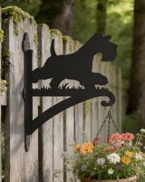 Digital representation of Steel Running Miniature Schnauzer Hanging Basket Bracket mounted on a mossy garden fence