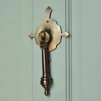 Antique Brass Door knocker on pastel green door door Antique Brass Door knocker on pastel green door door