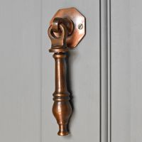 Pendulum traditional door knocker on grey door Pendulum traditional door knocker on grey door