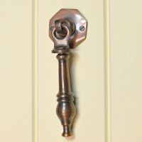 Antique Copper door knocker on Cream door Antique Copper door knocker on Cream door