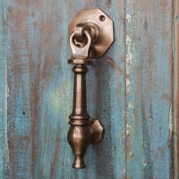 Antique Copper door knocker on rustic blue door Antique Copper door knocker on rustic blue door