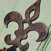 Close up of French Fleur de lys symbol door knocker