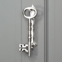 Bright Chrome Key door knocker on Grey Door