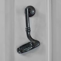 Black Golf Club Door Knocker on Grey Background Black Golf Club Door Knocker on Grey Background