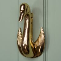 Brass Swan design door knocker on Green door Brass Swan design door knocker on Green door