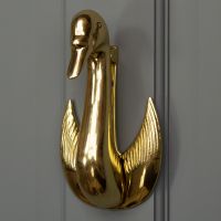 Swan door knocker on grey door Swan door knocker on grey door