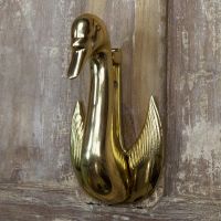 Swan design door knocker mounted on Brown door Swan design door knocker mounted on Brown door