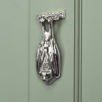 Bright Chrome Bat Door Knocker on pale Green Door Bright Chrome Bat Door Knocker on pale Green Door