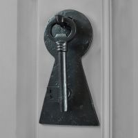 Black Iron Key door knocker on grey door