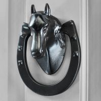 Black Equestrian door knocker on grey door Black Equestrian door knocker on grey door