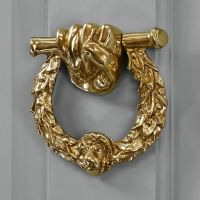 Polished Brass Fist & Laurel door knocker on grey door Polished Brass Fist & Laurel door knocker on grey door