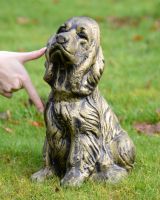 Brushed Gold Spaniel Dog garden Sculpture with hand in shot for scale