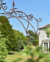 Close up of intricate scrollwork detail on rustic rose arch Close up of intricate scrollwork detail on rustic rose arch