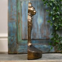 Side view of animal feline door stop