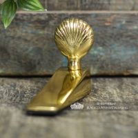 Polished Brass Shell Design Door Wedge From the Front