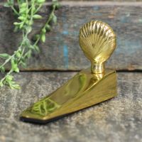 Shell Design Door Wedge in Situ Next to a Rustic Door