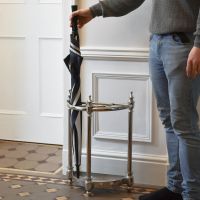 Antique Nickel "Half-Moon" Umbrella Stand with Male for Scale  Antique Nickel "Half-Moon" Umbrella Stand with Male for Scale