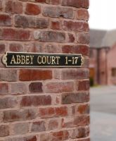 The "Warrington’ Modern Brass House Sign