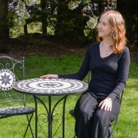 The "Santa Oliva" Foldable 2-Seater Mosaic Dining Set Scale Shot In A Garden The "Santa Oliva" Foldable 2-Seater Mosaic Dining Set Scale Shot In A Garden