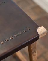 Cross-stitch detailing on leather seat.