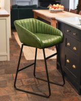 Stylish green leather bar stool with iron framework.