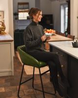 Stylish green leather and iron bar stool for scale.