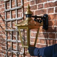 Standard Antique Brass Top Fix Wall Lantern with Hand for Scale 