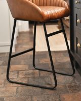 Iron framework supporting the leather seat.