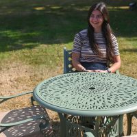 The “Gardenia” Deluxe 4-Seater Outdoor Dining Set - Sage Green Scale Shot In A Garden