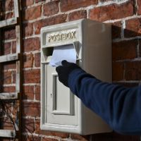 Letter being posted through Traditional Cream & Gold Post Box