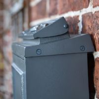 Close-Up of Side View of Simplistic Post Box on House Wall 