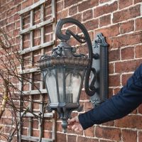 "Cotswold Collection" Extra Large Wall Lantern with hand for scale 