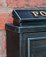 The Antique Green "Oxford" Wall Mounted Post Box with Gold Detailing Showing The Top Left Corner The Antique Green "Oxford" Wall Mounted Post Box with Gold Detailing Showing The Top Left Corner