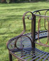 Ornate armrests on the Bronze ornate antique tree bench.