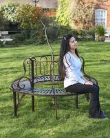 Bronze ornate antique tree bench for scale.
