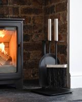 The “Birchdale Avenue” Fireplace Brush and Pan Set  on a Black Stone Hearth next to a Log Burner Stove - Digital Illustration