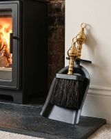 The Black and Polished Brass Pan and Brush Set next to a Traditional Cottage Fireplace - Digital Illustration