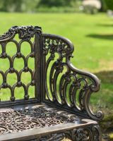 Close up of intricate arm detail on garden bench
