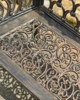 Close up of ornate seat detail on 2 seater garden bench