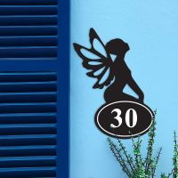 Fairy Iron House Number Sign in Situ on a Blue Wall  Fairy Iron House Number Sign in Situ on a Blue Wall