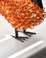 Close up detail on orange recycled metal cockerel sculpture Close up detail on orange recycled metal cockerel sculpture