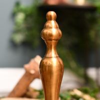 Close up of finial on antique brass fire grate fire dog