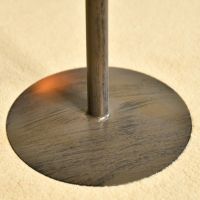 Close up of circular companion set in rustic finish 