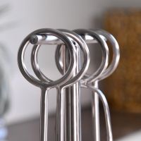 Close up of circular handles on brushed steel companion set