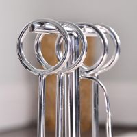Close up of circular handles on polished steel companion set 