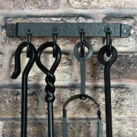 4 Hook "Blacksmith Style" Wall Mounted Fireside Tool Rack in Situ on the Wall holding tools 4 Hook "Blacksmith Style" Wall Mounted Fireside Tool Rack in Situ on the Wall holding tools