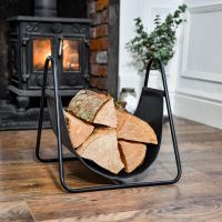 Black Steel & Black Leather Log Holder on Wooden Floor Black Steel & Black Leather Log Holder on Wooden Floor