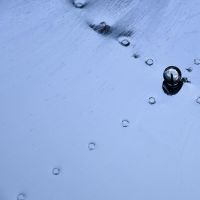 Close up of circular lid with decorative detailing and ball handle 
